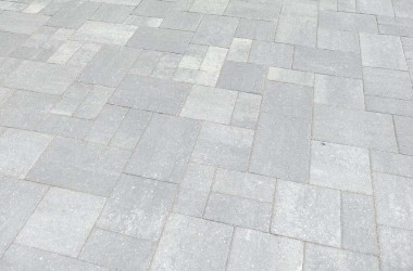 Sealed driveway in Florida home boosting curb appeal with beautifully restored pavers.